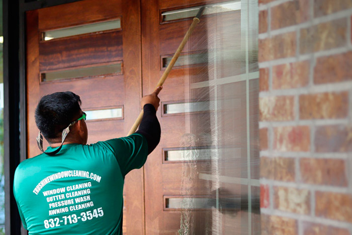 TruShine technician cleaning exterior windows in Houston